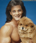 Beefy topless dude posing with hairy dog.