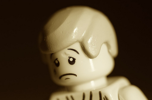 Lego figurine with sad face.